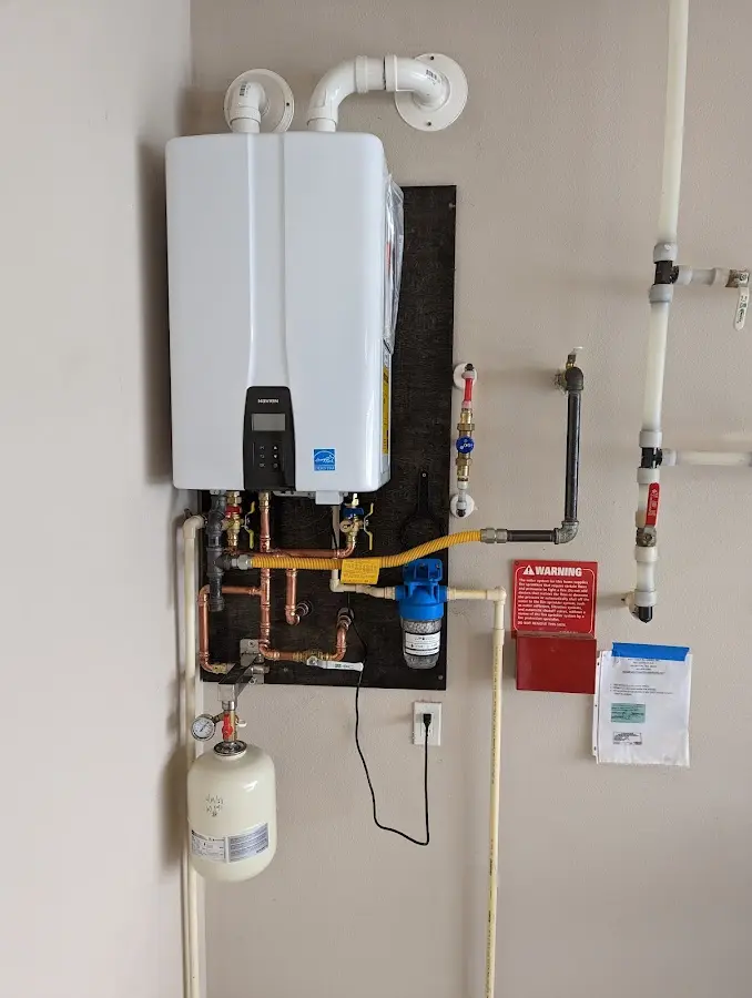 Professional plumber installing copper piping in a Pleasant View home